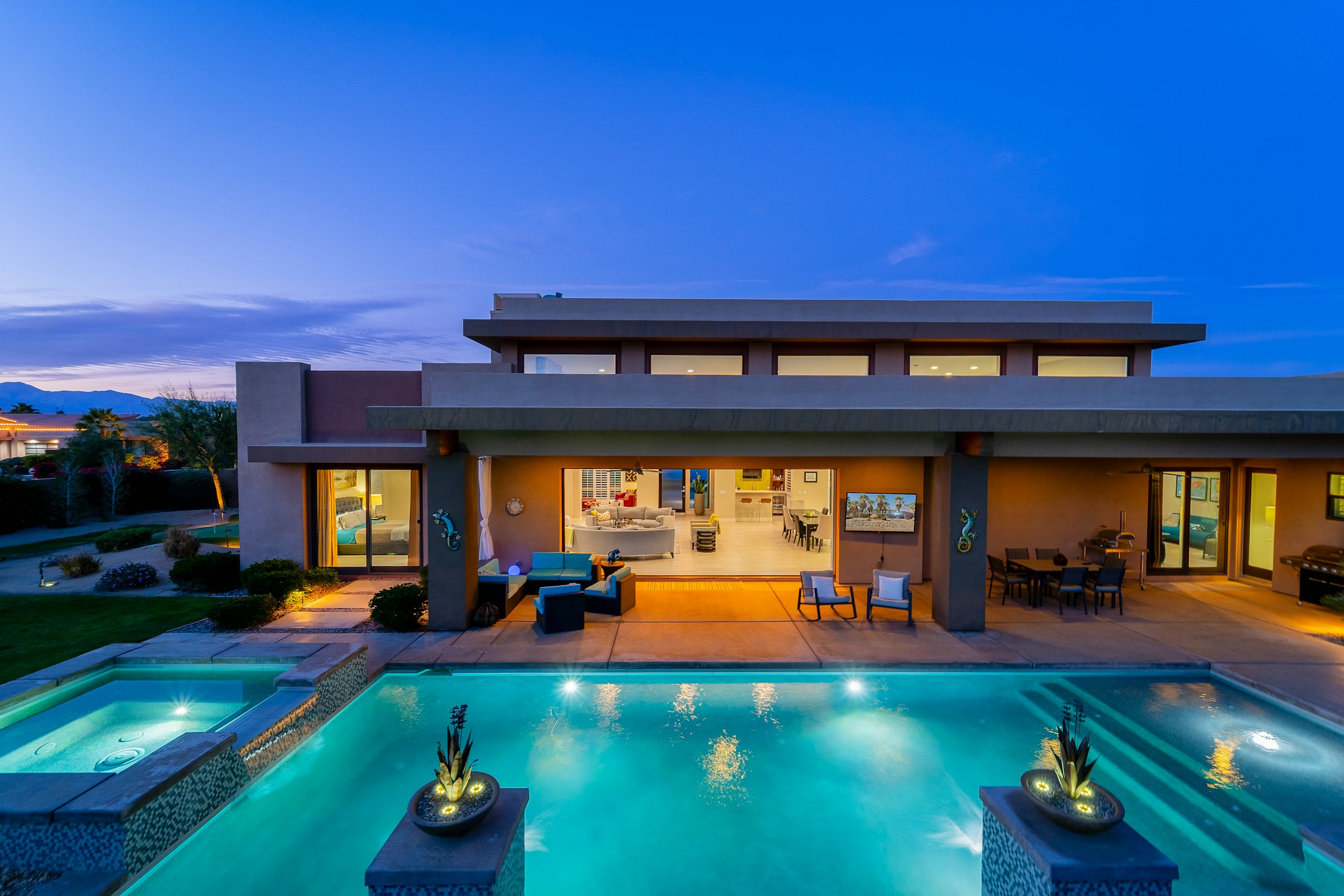 Modern desert villa at dusk with reflecting pool